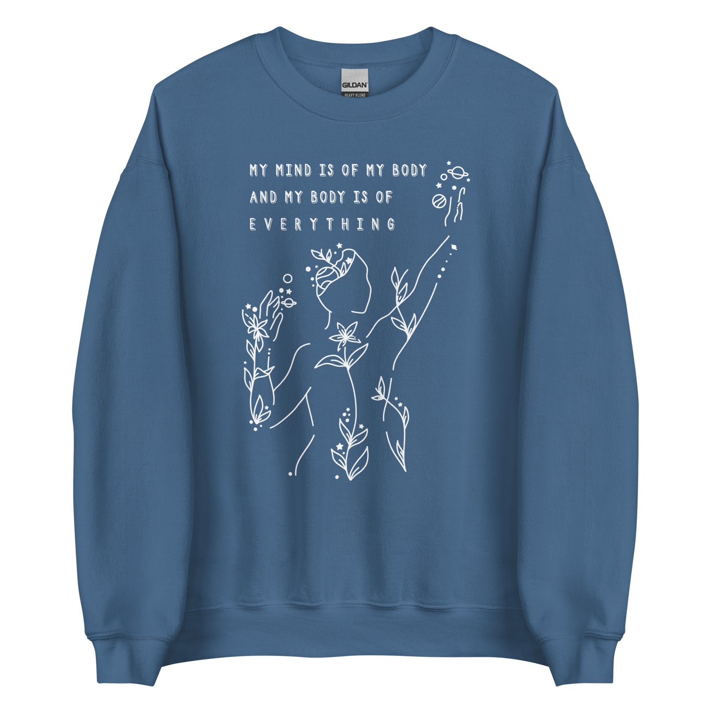 A blue crewneck sweatshirt featuring an abstract illustration of a figure whose body is spreading out into plants and planets and stars. Text above the figure reads "My mind is of my body and my body is of everything."