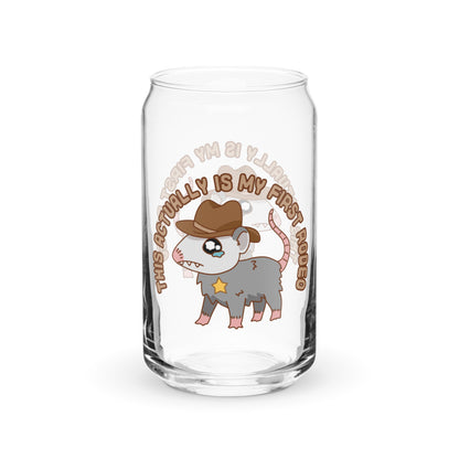 A can-shaped glass featuring an illustration of a nervous-looking possum wearing a cowboy hat and sherrif star. Text above the possum reads "This actually IS my first rodeo".