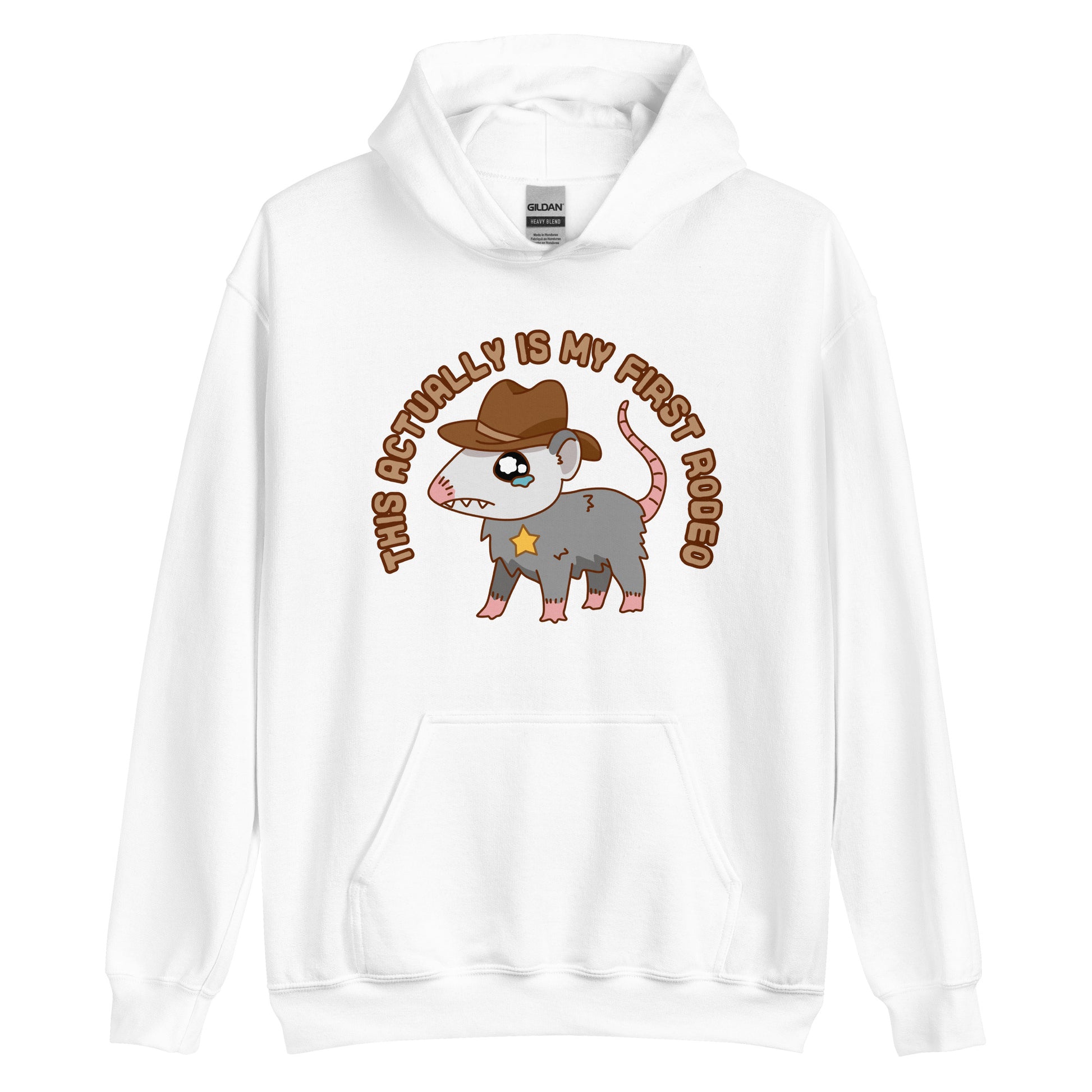 A white hooded sweatshirt featuring an illustration of a cute and nervous possum wearing a cowboy hat and sherrif's star badge. Text above the possum in an arc reads "this actually is my first rodeo".