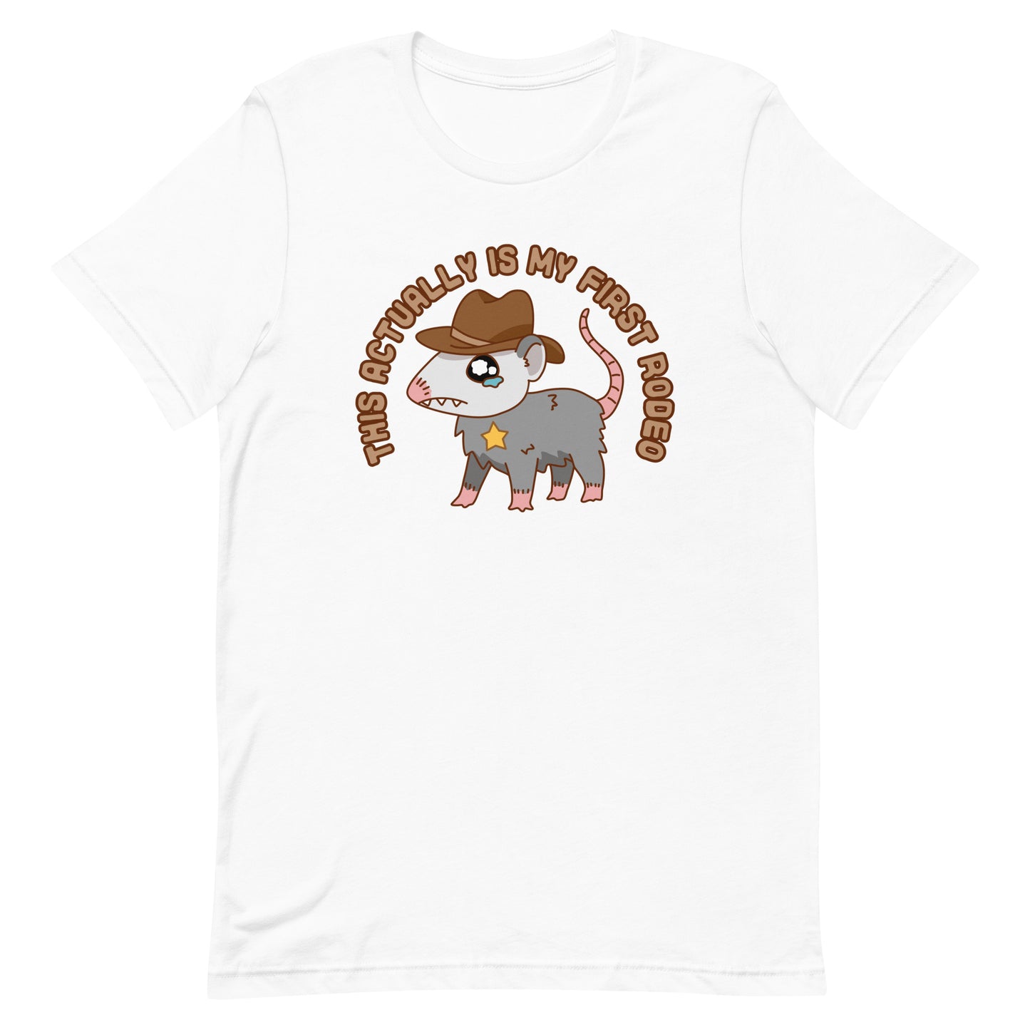 A white crewneck t-shirt featuring an illustration of a cute and nervous possum wearing a cowboy hat and sherrif's star badge. Text above the possum in an arc reads "this actually is my first rodeo".