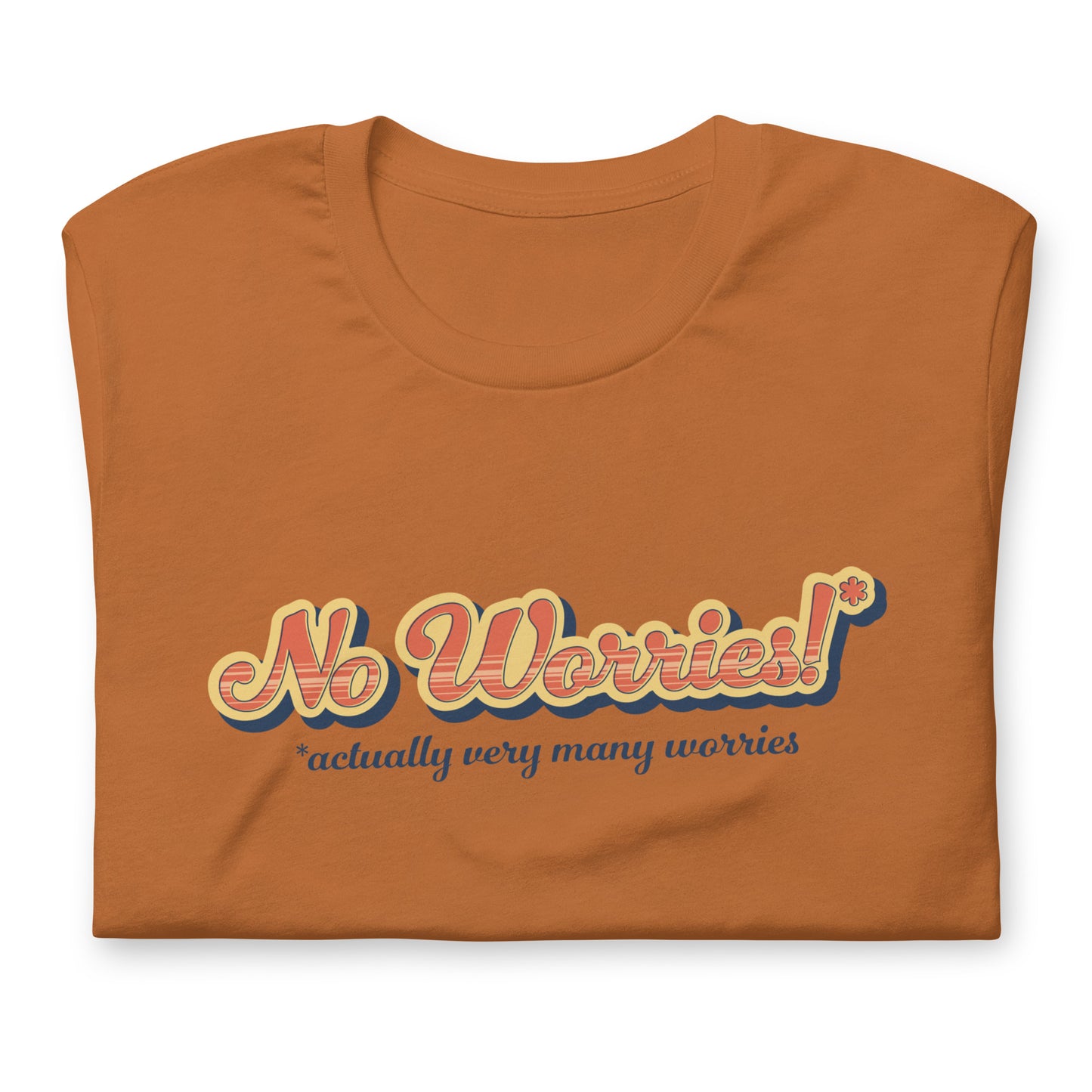 A close up image of a folded orange crewneck t-shirt featuring vintage-style text that reads "No worries!* *actually very many worries"
