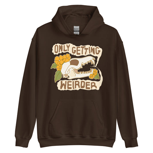 A dark brown hooded sweatshirt featuring an illustration of a fox skull surrounded by yellow flowers. Wobbly speech bubbles are coming from the fox's mouth. The text inside the bubbles reads "ONLY GETTING WEIRDER".