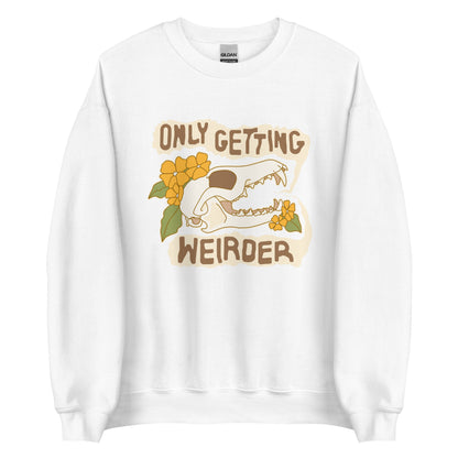 A white crewneck sweatshirt featuring an illustration of a fox skull surrounded by yellow flowers. Wobbly speech bubbles are coming from the fox's mouth. The text inside the bubbles reads "ONLY GETTING WEIRDER".