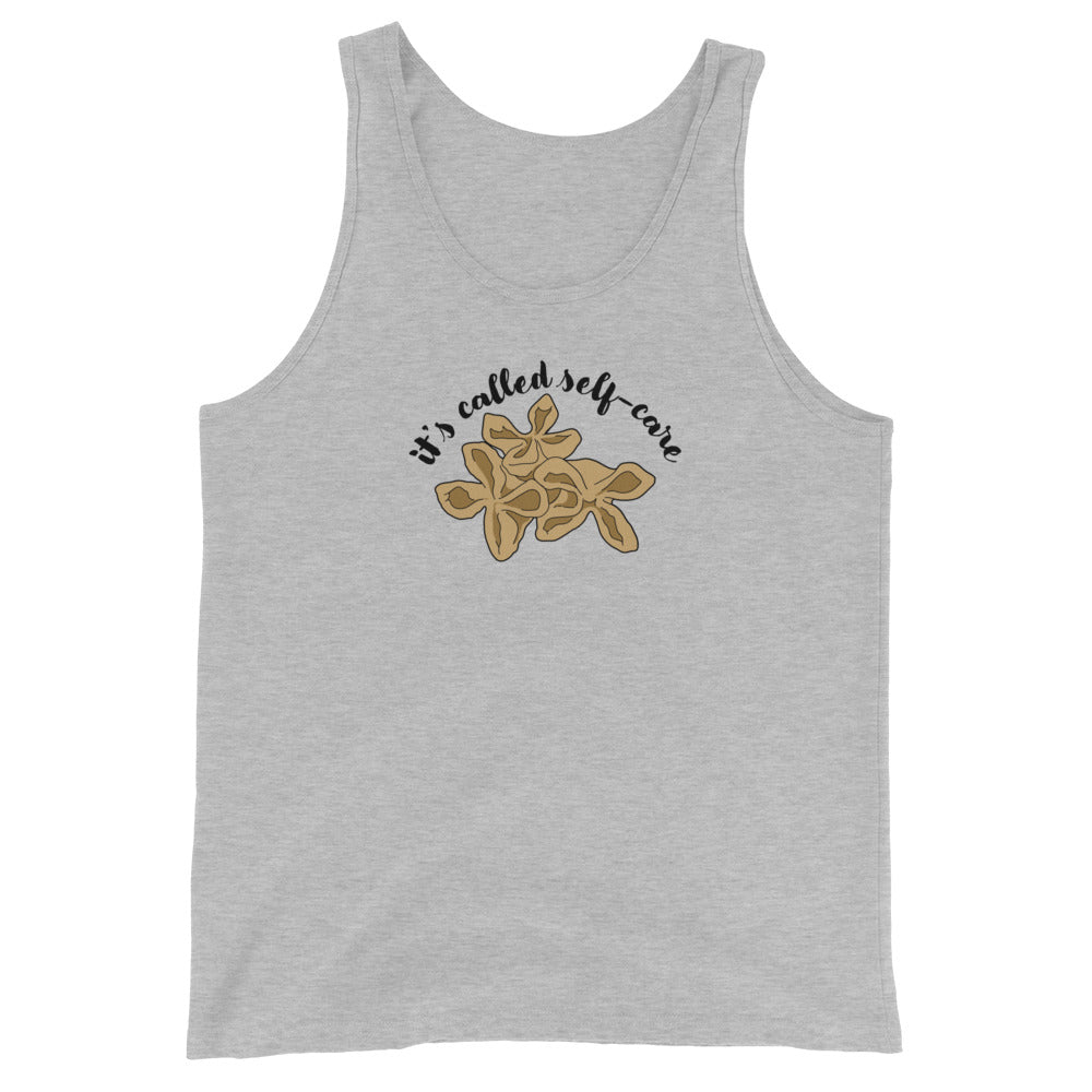 A grey tank top featuring an illustration of three pieces of crab rangoon. Text in an arc above the crab rangoon reads "it's called self-care" in a cursive script.
