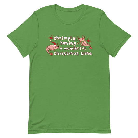 A green crewneck t-shirt featuring an illustration of two festive shrimp - one with a Santa hat, and one with reindeer antlers. Text between the shrimp reads "shrimply having a wonderful Christmas time".