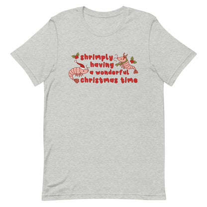 A grey crewneck t-shirt featuring an illustration of two festive shrimp - one with a Santa hat, and one with reindeer antlers. Text between the shrimp reads "shrimply having a wonderful Christmas time".
