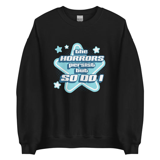 A black crewneck sweatshirt featuring blue and white stars over a halftone pattern with chunky text that reads "the horrors persist but so do i".