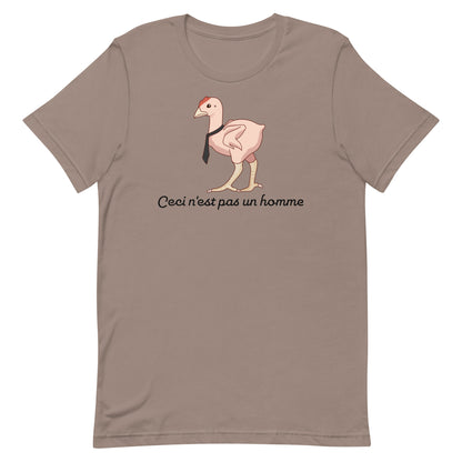 A grey-brown crewneck t-shirt featuring an illustration of a featherless chicken wearing a tie. Text underneath the chicken reads "Ceci n'est pas un homme" in a cursive font.