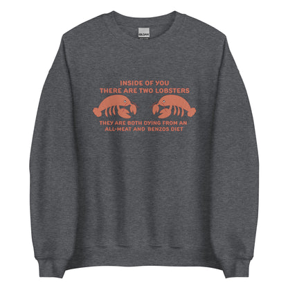 A dark grey crewneck sweatshirt featuring an illustration of two lobsters. Text around the lobsters reads "Inside of you there are two lobsters. They are both dying from an all-meat and benzos diet."