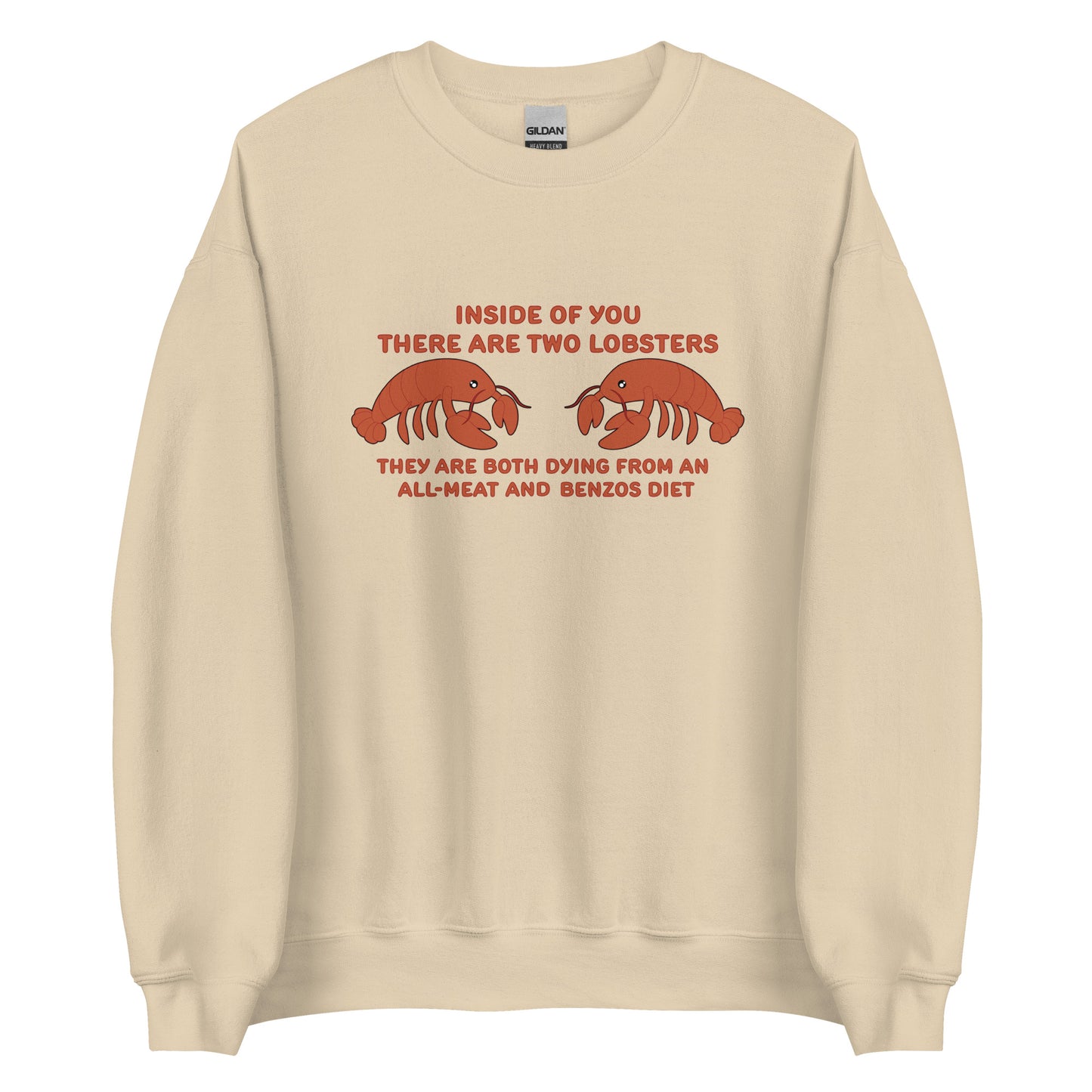 A tan crewneck sweatshirt featuring an illustration of two lobsters. Text around the lobsters reads "Inside of you there are two lobsters. They are both dying from an all-meat and benzos diet."