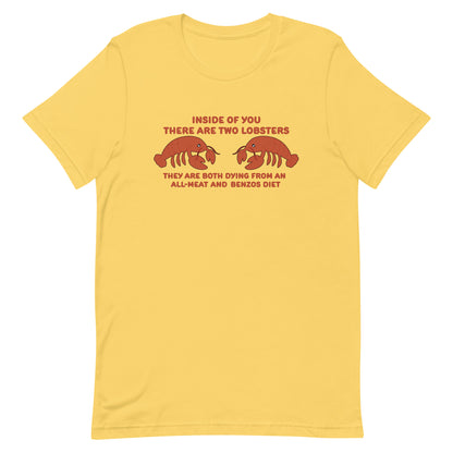 A yellow crewneck t-shirt featuring an illustration of two lobsters surrounded by text that reads "Inside of you there are two lobsters. They are both dying from an all-meat and benzos diet"