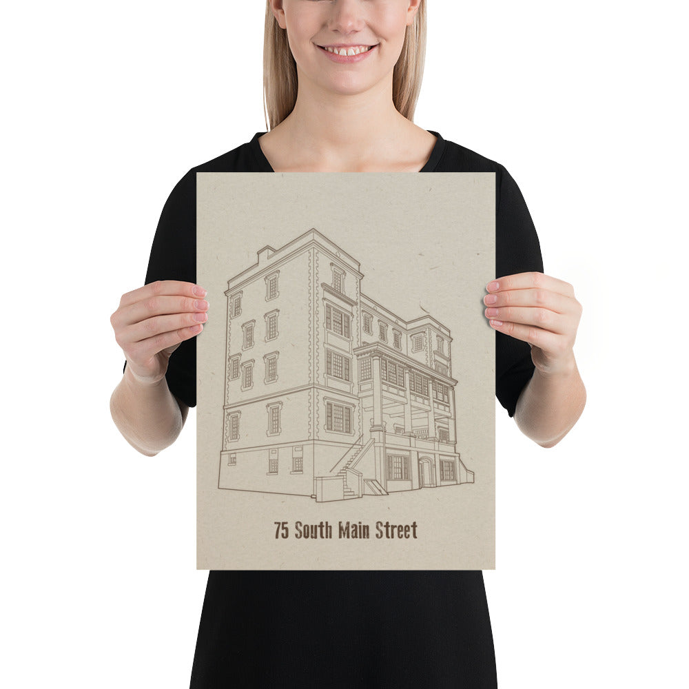 A woman holding an 12 inch by 16 inch print. The print is a sepia tone illustration of a building. The building is labeled "75 South Main Street"