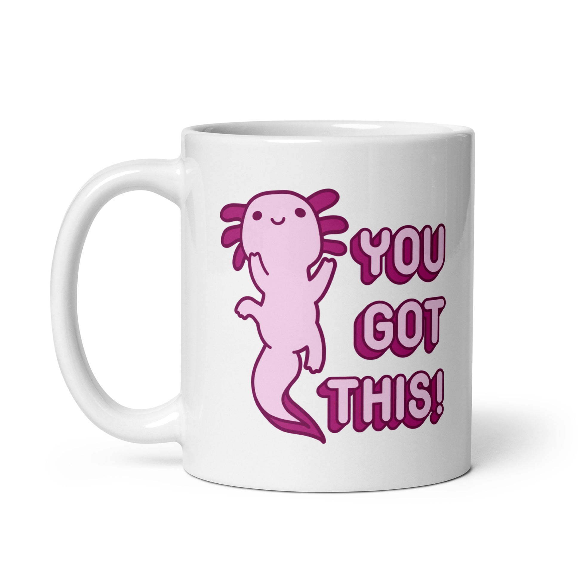 An 11oz white coffee mug with the handle on the left-hand side with a picture of a pink axolotl and the words "You Got This!" in pink bubble letters