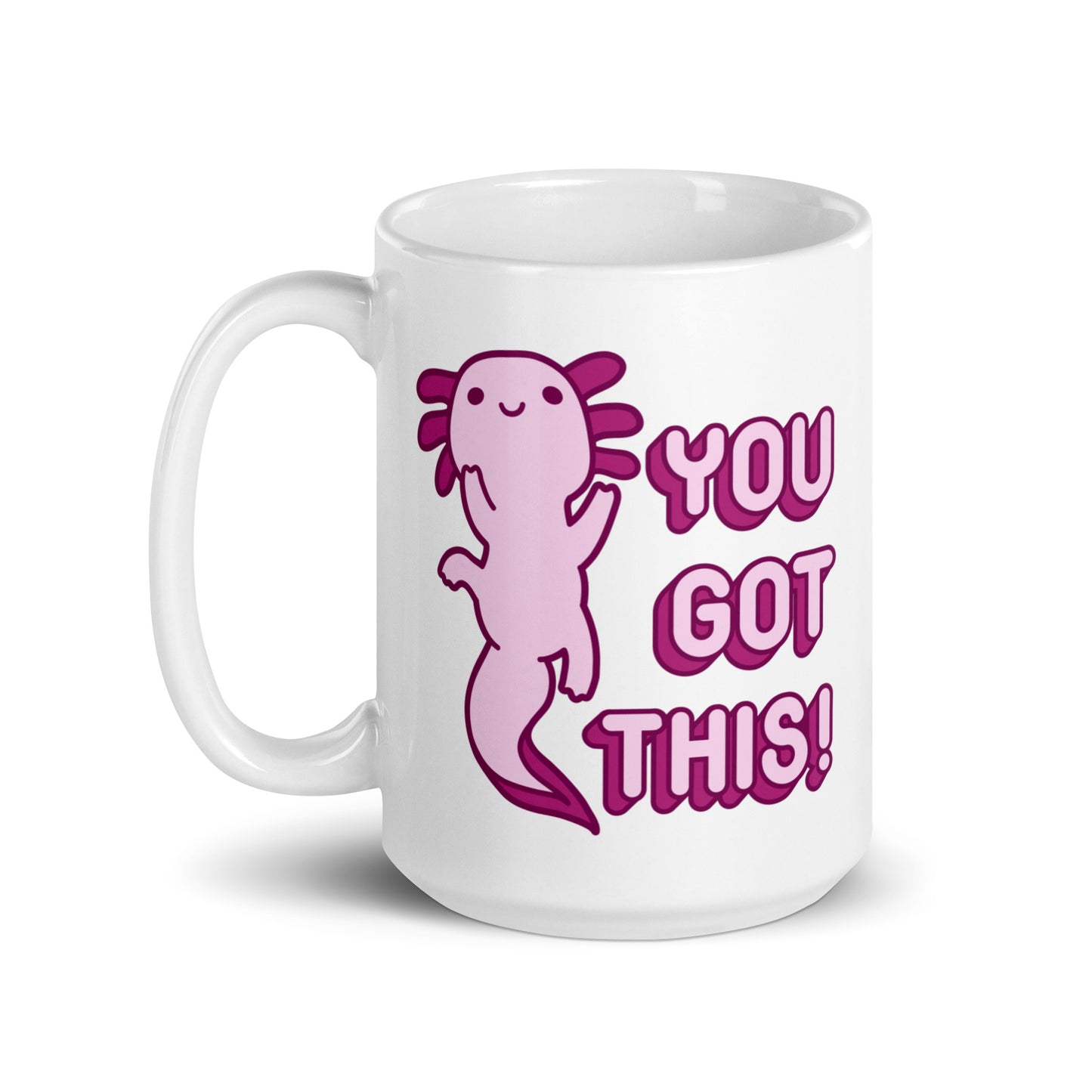 A 15 oz white coffee mug with the handle on the left-hand side with a picture of a pink axolotl and the words "You Got This!" in pink bubble letters
