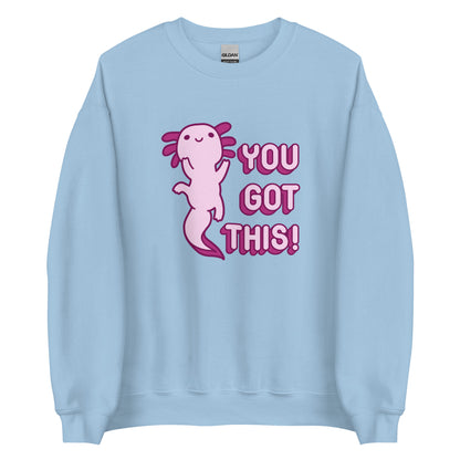 A light blue crewneck sweatshirt featuring a picture of a a pink axolotl and the words "You Got This!" in pink bubble letters