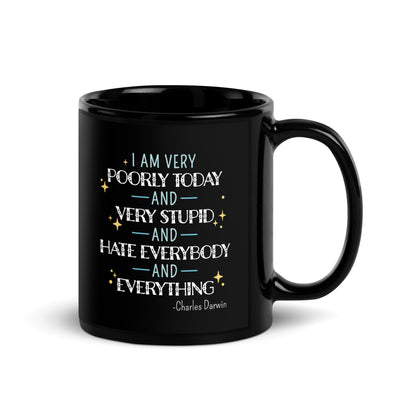 A black ceramic 11 ounce mug with a quote from Charles Darwin in white and blue text. The quote reads "I am very poorly today and very stupid and hate everybody and everything".