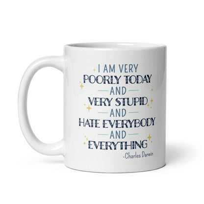 A white ceramic 11 ounce mug with a quote from Charles Darwin in blue text. The quote reads "I am very poorly today and very stupid and hate everybody and everything".