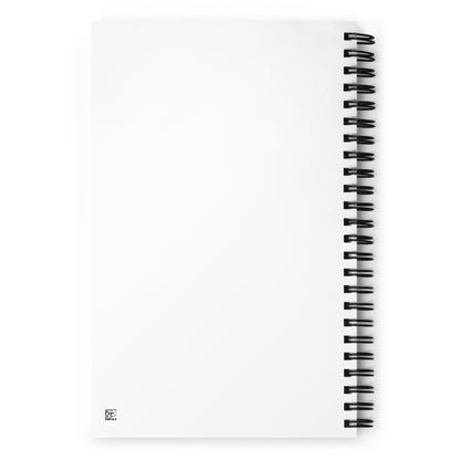 The back of a white wire-bound notebook. The back surface is blank with no decoration.