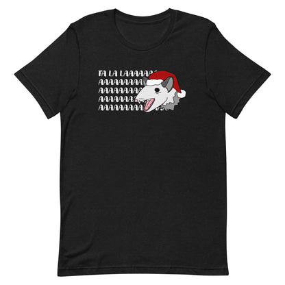 A black crewneck t-shirt featuring an illustration of a possum wearing a Santa hat. The possum appears to be screaming, and text behind his head reads "FA LA LAAAAAA"