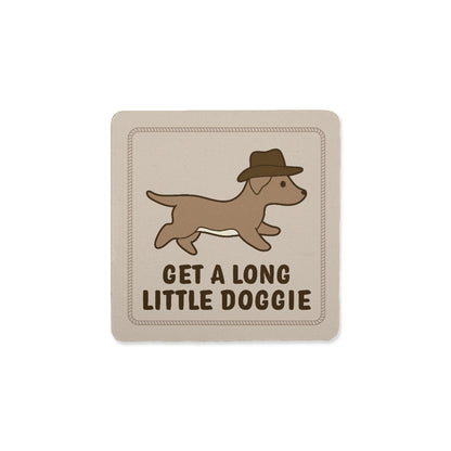 A square coaster with an image of a dachshund in a cowboy hat. Text below the dog reads "Get a long little doggie"