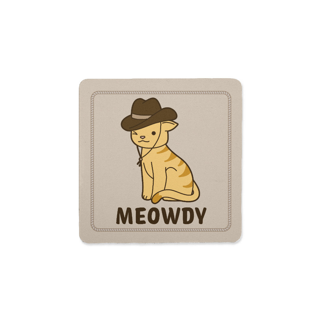 A square coaster featuring an image of a yellow cat with stripes wearing a cowboy hat. The cat is winking, and text below the cat reads "Meowdy"