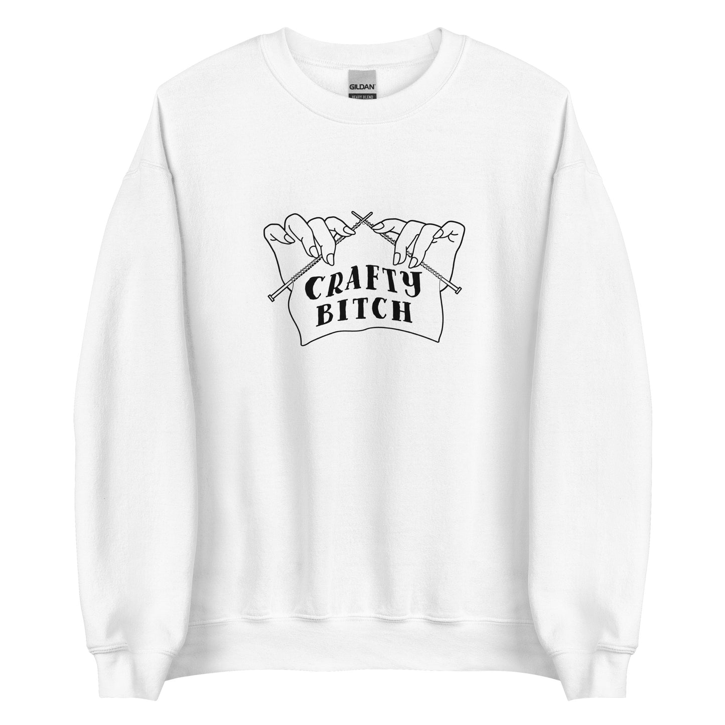 A white crewneck sweatshirt featuring a single-color illustration of a pair of hands holding knitting needles. Fabric on the needles features text that reads "crafty bitch".