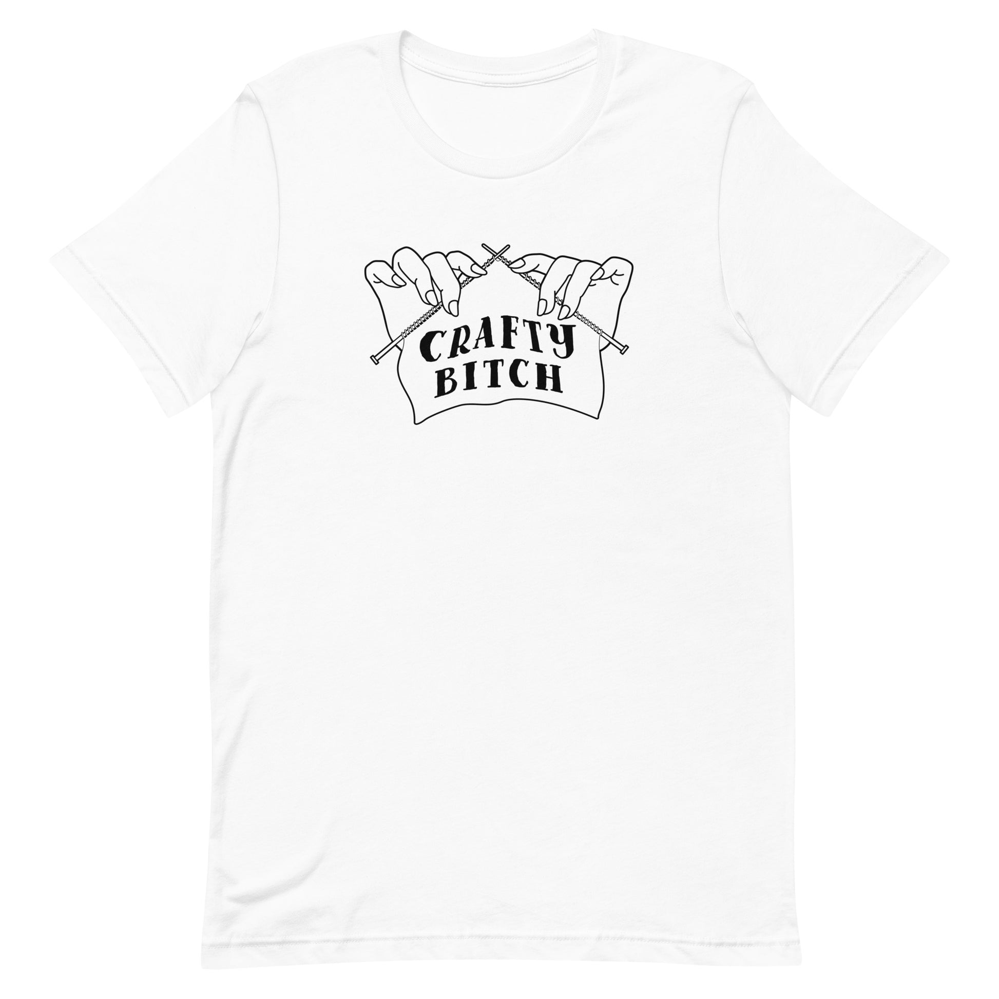 A white crewneck t-shirt featuring a single-color illustration of a pair of hands holding knitting needles. Fabric on the needles features text that reads "crafty bitch".