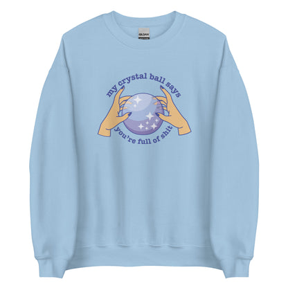 A light blue crewneck sweatshirt with a picture of hands on a crystal ball and text reading "My crystal ball says you're full of shit"