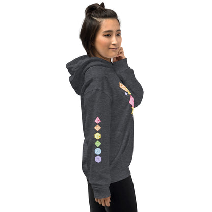 A woman wearing a hooded dark grey sweatshirt, facing to the right. On the sleeve of the sweatshirt is the image of six polyhedral dice in pastel rainbow colors.