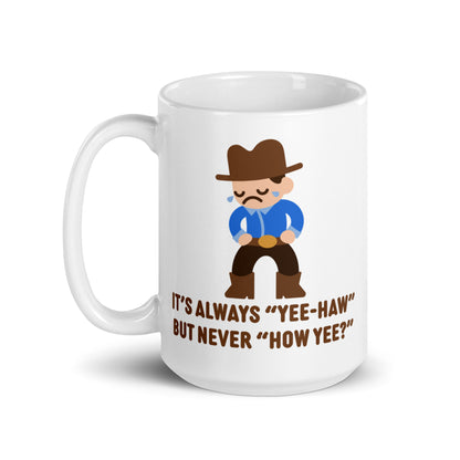 A white 15 ounce ceramic coffee mug featuring an illustration of a crying cowboy wearing a blue shirt. Text below the cowboy reads "It's always "yee-haw" but never "How yee?""