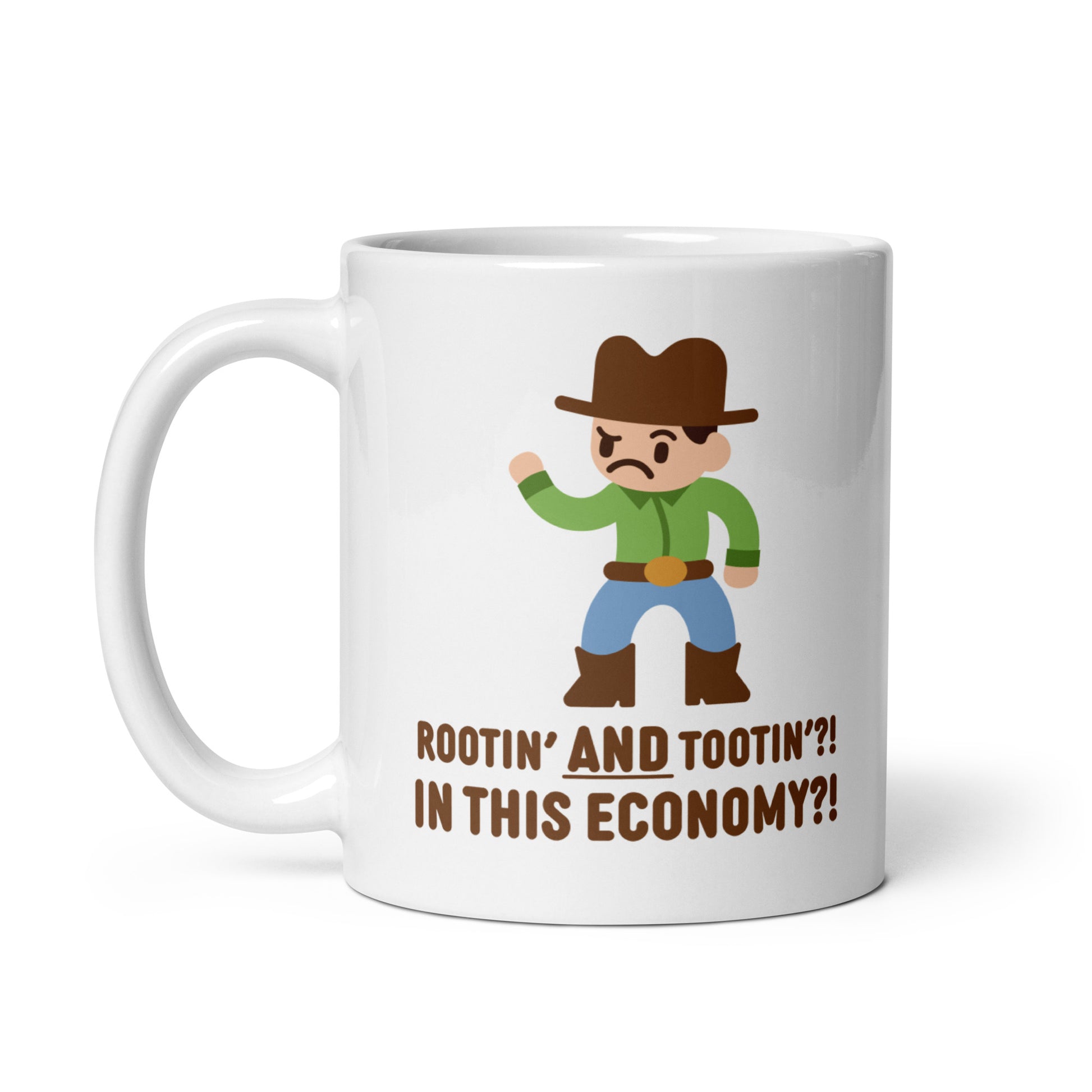 A white 11 ounce ceramic coffee mug featuring an illustration of a confused-looking cowboy wearing a green shirt. Text underneath the cowboy reads "Rootin' AND tootin'?! In this economy?!"