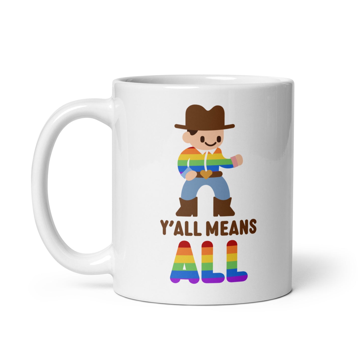 A white 11 ounce coffee mug featuring an illustration of a smiling cowboy wearing a rainbow striped shirt. Text underneath the cowboy reads "Y'all means ALL". The word "ALL" is rainbow-colored to match the cowboy's shirt.