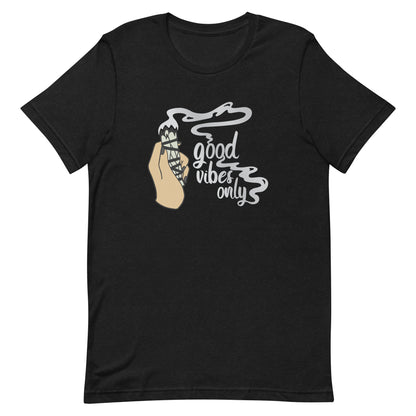 A black crewneck t-shirt featuring an illustration of a hand holding a sage smudge stick. Smoke is flowing from the tip of the sage and forms text reading "good vibes only"
