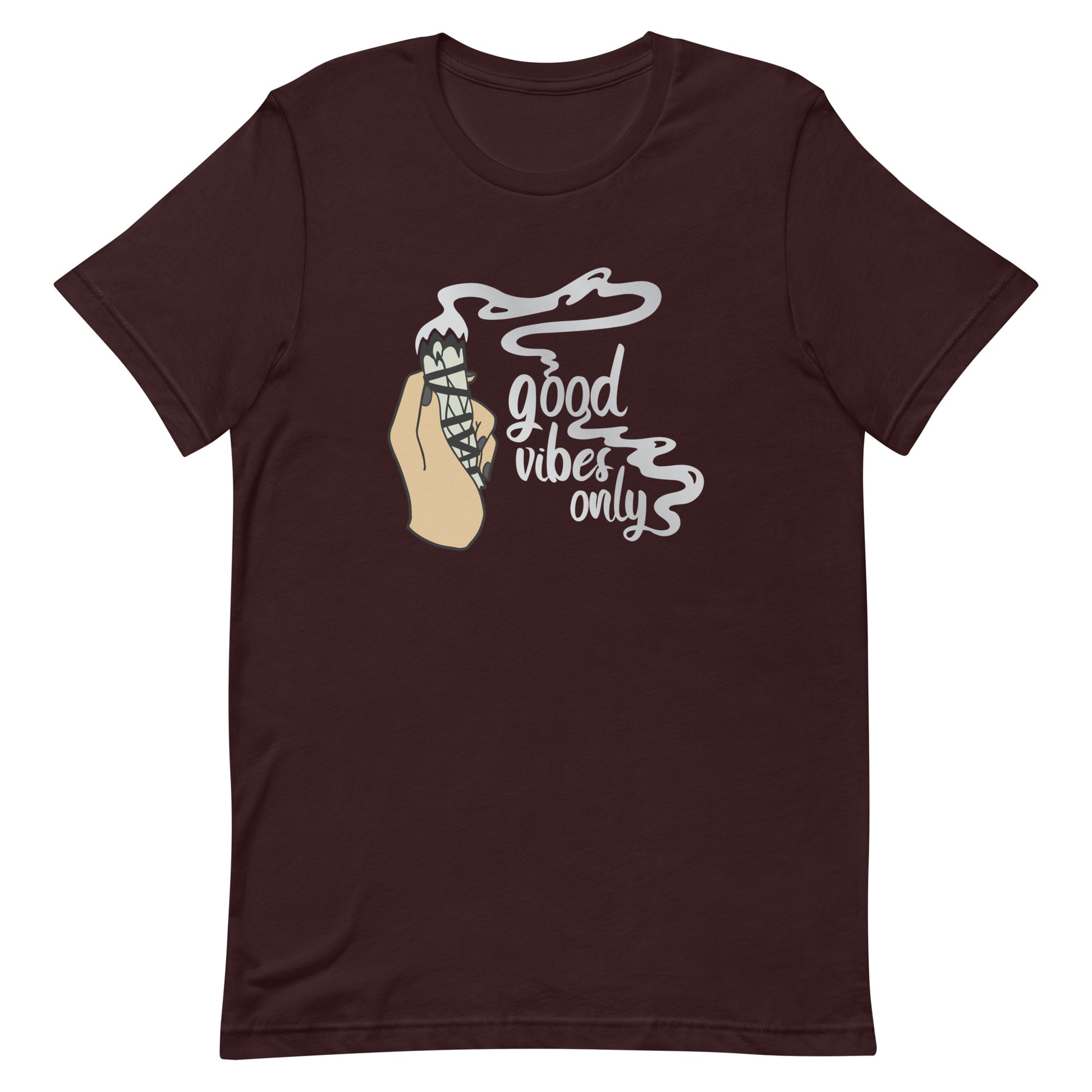 A maroon crewneck t-shirt featuring an illustration of a hand holding a sage smudge stick. Smoke is flowing from the tip of the sage and forms text reading "good vibes only"