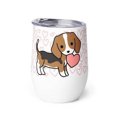 A white metal wine tumbler with a plastic lid. A pattern of hearts wraps around the top half of the tumbler. Centered on the tumbler is a cute, stylized illustration of a Beagle