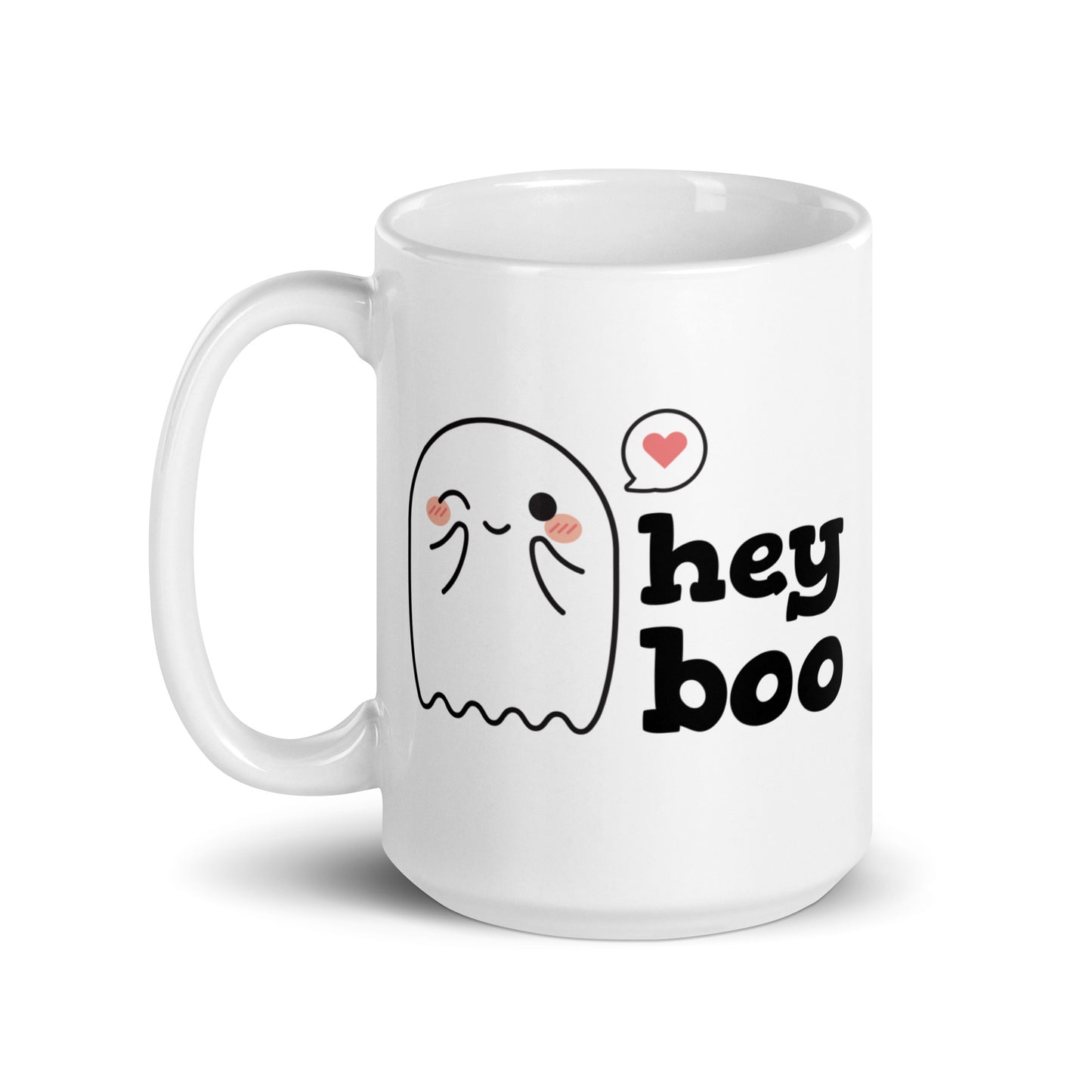 A white 15 ounce coffee mug featuring an illustration of a blushing and smiling ghost next to text that reads "hey boo"