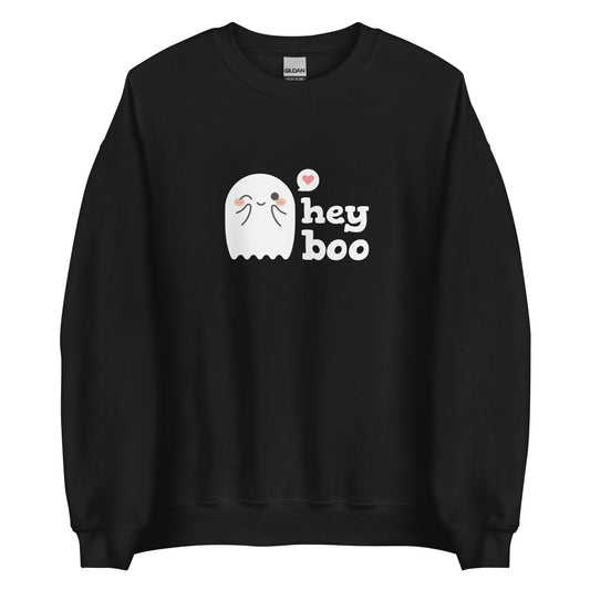A black crewneck sweatshirt featuring an image of a cute smiling and blushing ghost. Text alongside the ghost reads "hey boo"