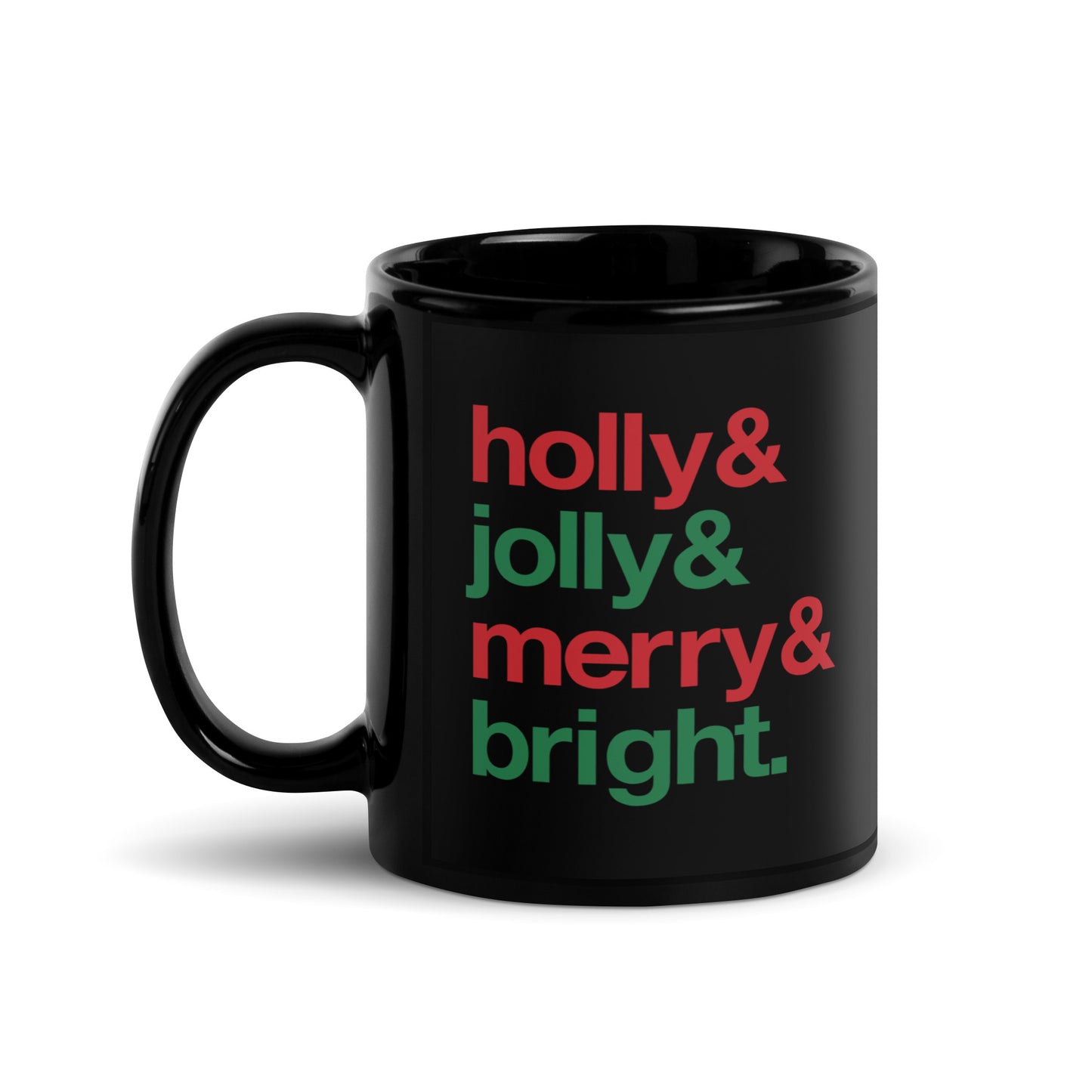 A black 11 ounce ceramic mug with four lines of red and green text that read "Holly & Jolly & Merry & Bright"