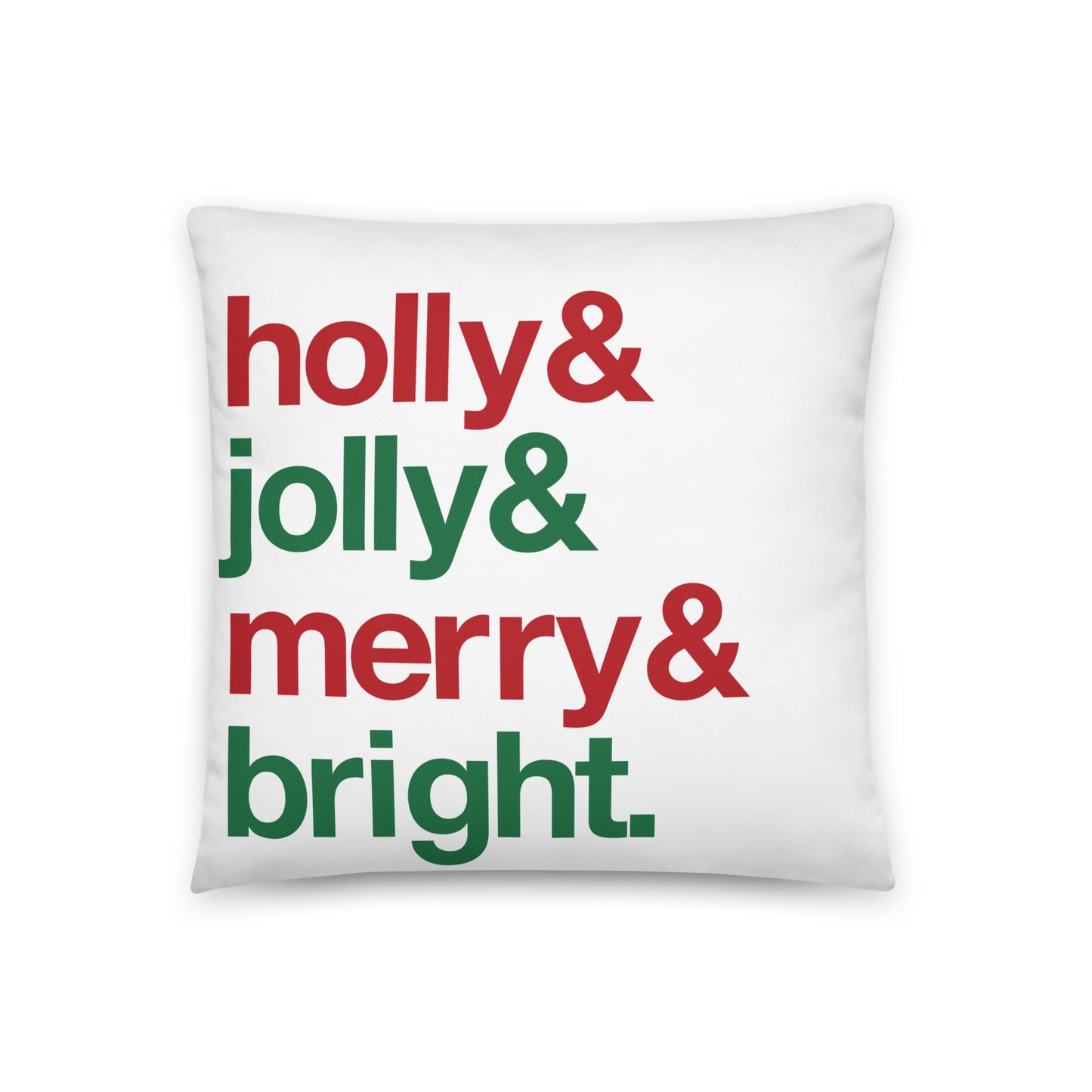 An 18" by 18" throw pillow decorated with four lines of red and green text that read "Holly & jolly & merry & bright". 