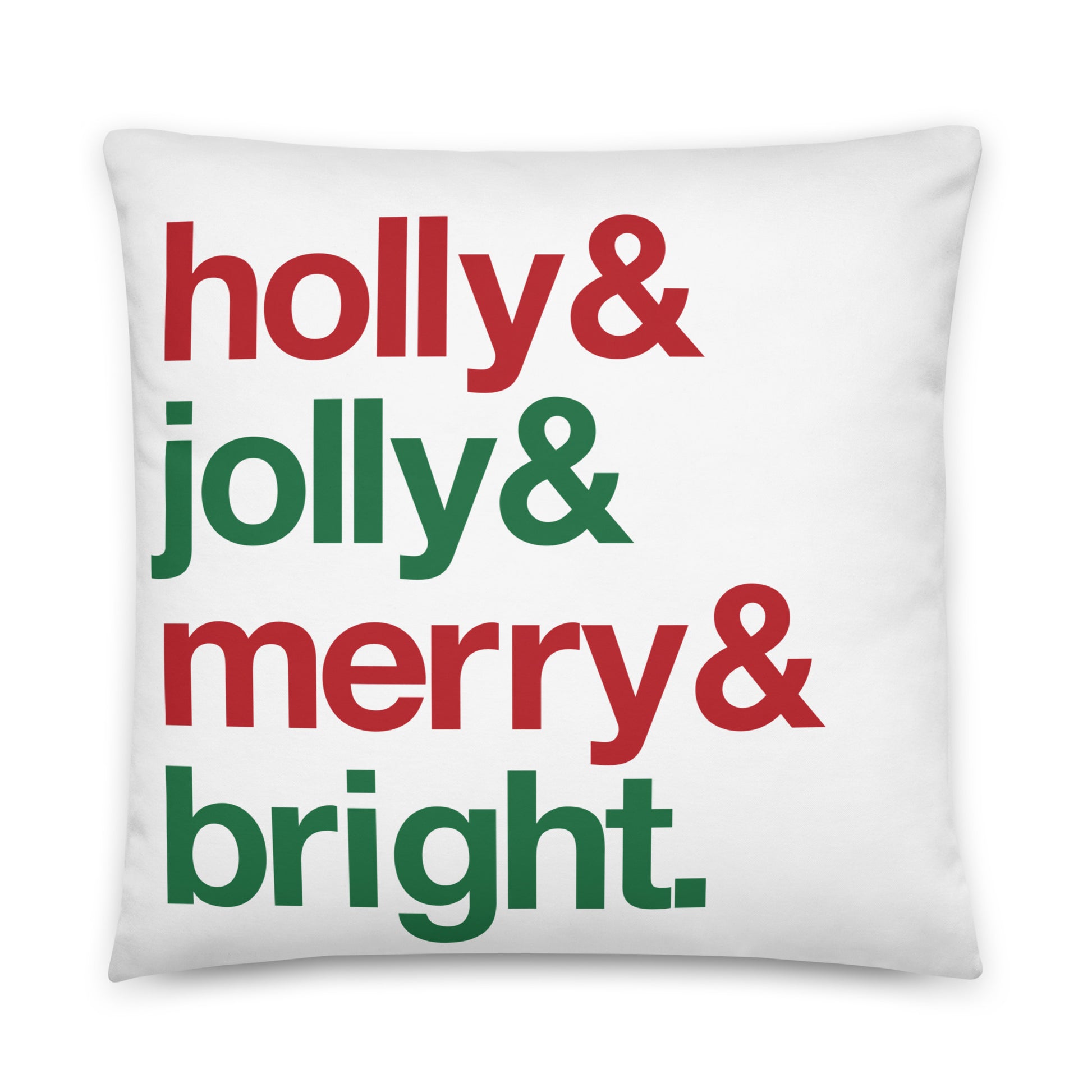 A 22" by 22" throw pillow decorated with four lines of red and green text that read "Holly & jolly & merry & bright".