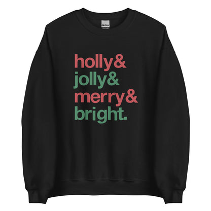 A black crewneck sweatshirt featuring four lines of red & green text that read "Holly & jolly & merry & bright"