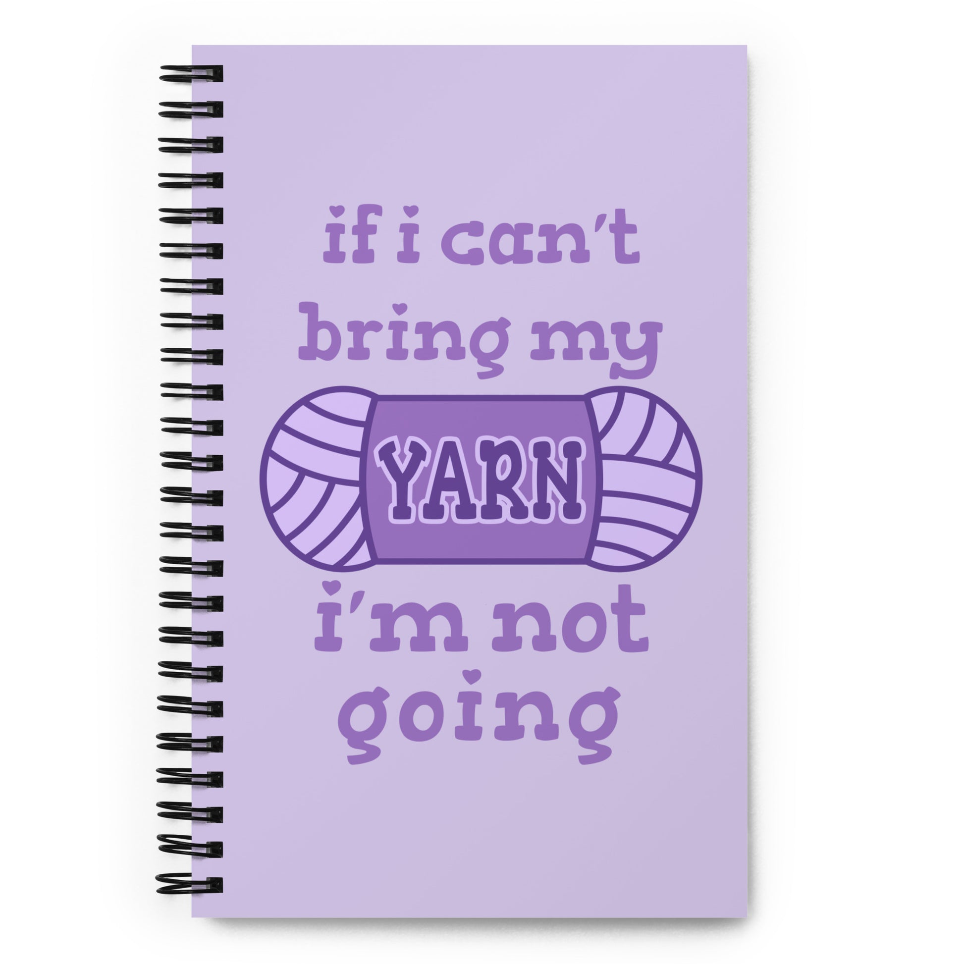 A light purple wire-bound notebook with text reading "If I can't bring my yarn, I'm not going". The word "yarn" is centered on an illustration of a skein of yarn.