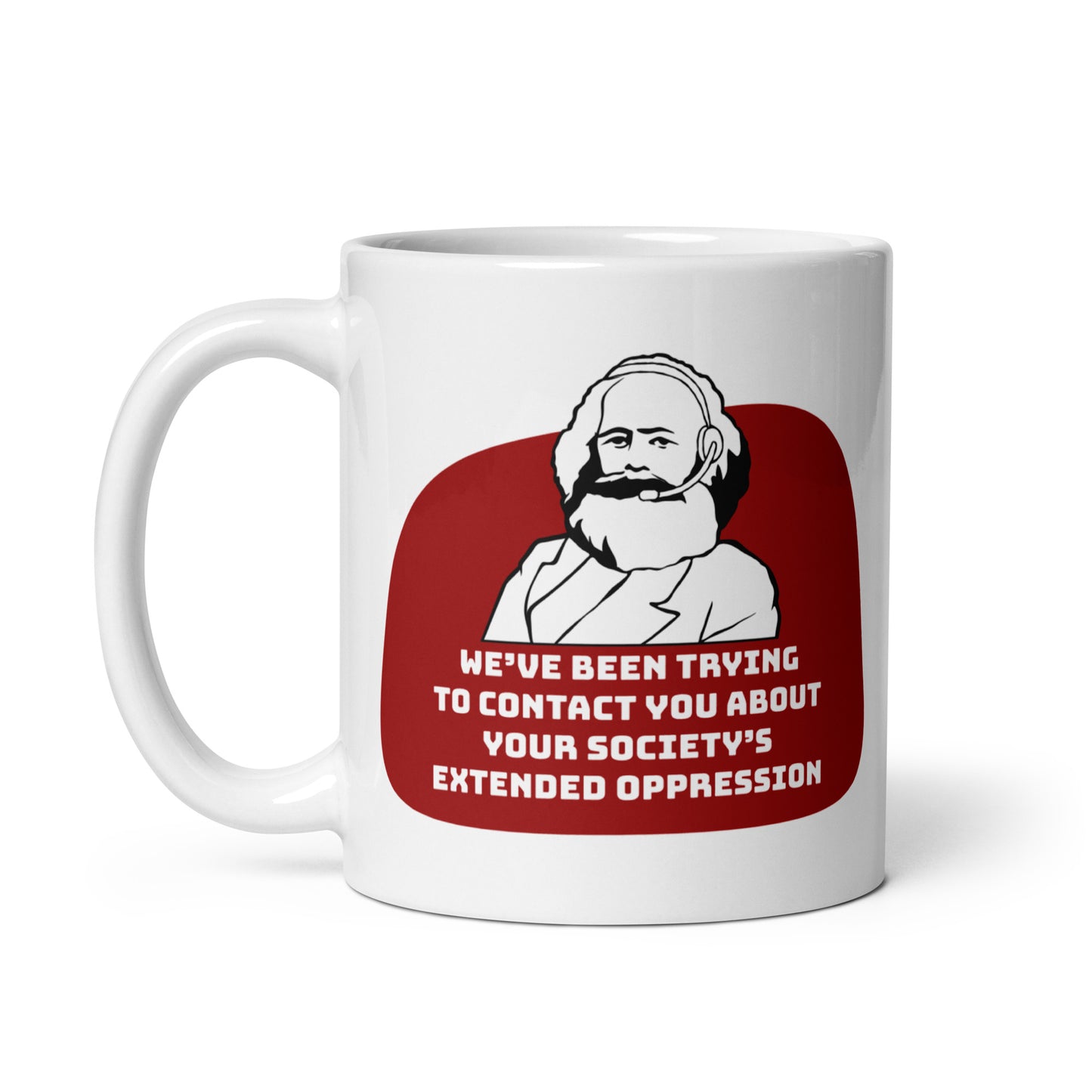 An 11 ounce, white ceramic mug featuring a black and white illustration of Karl Marx wearing a telemarketer headset. Text beneath Marx reads "We've been trying to contact you about your society's extended oppression." in a blocky font.