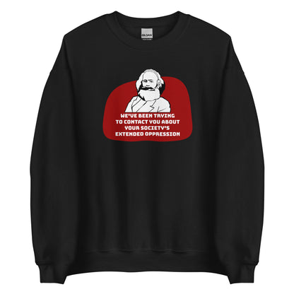 A black crewneck sweatshirt featuring a black and white illustration of Karl Marx wearing a telemarketer headset. Text beneath Marx reads "We've been trying to contact you about your society's extended oppression." in a blocky font.