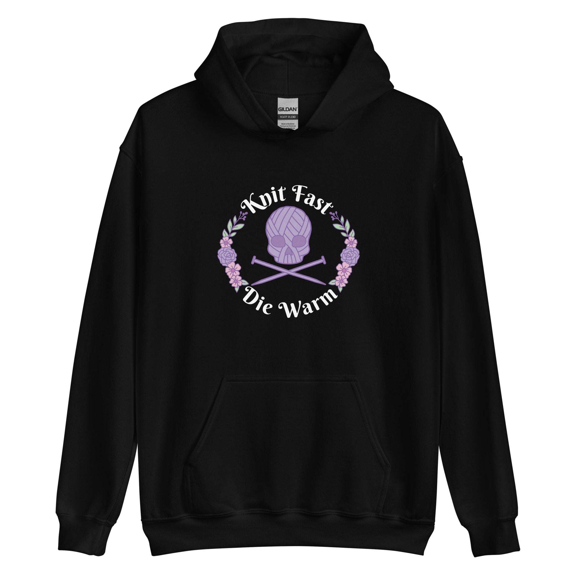 A black hooded sweatshirt featuring an image of a skull and crossbones made of yarn and knitting needles. A floral wreath surrounds the skull, along with words that read "Knit Fast, Die Warm"