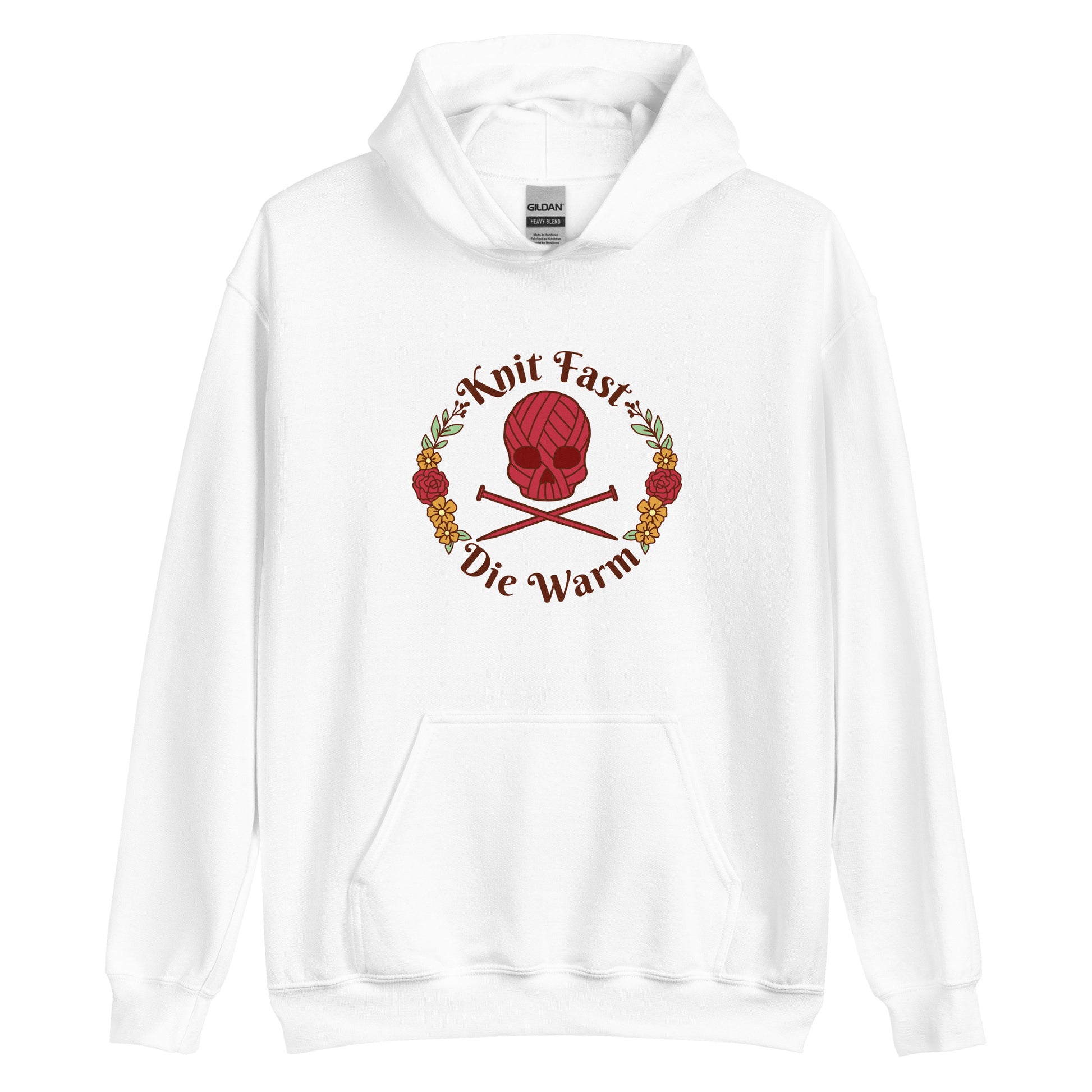 A white hooded sweatshirt featuring an image of a skull and crossbones made of yarn and knitting needles. A floral wreath surrounds the skull, along with words that read "Knit Fast, Die Warm"