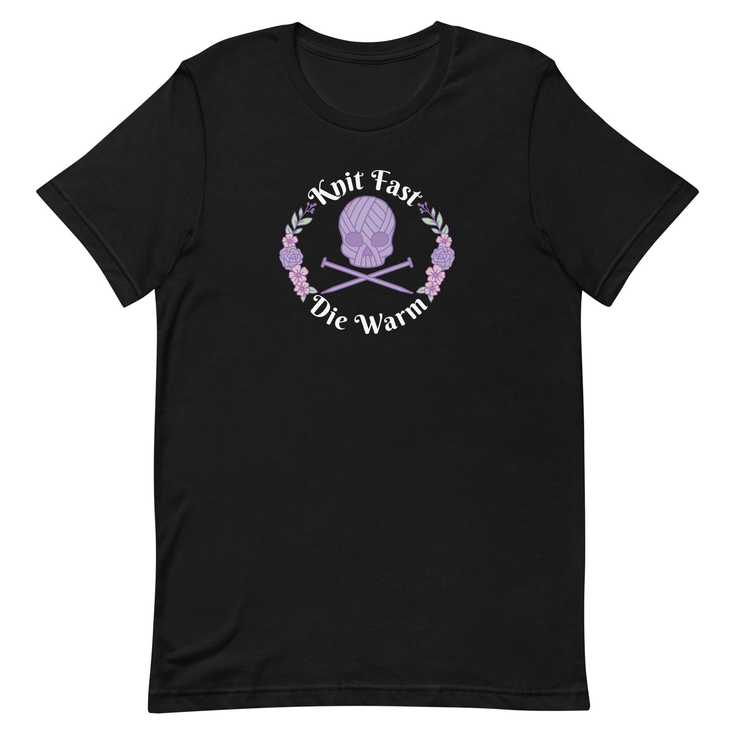 A black crewneck t-shirt featuring an image of a skull and crossbones made of yarn and knitting needles. A floral wreath surrounds the skull, along with words that read "Knit Fast, Die Warm"