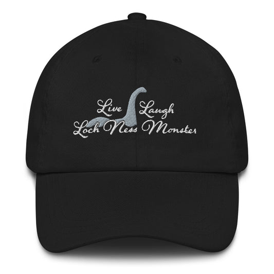 An image of the front side of a black baseball cap. White embroidered text decorates the front of the hat reading "Live Laugh Loch Ness Monster" with a silhouette of Nessie.