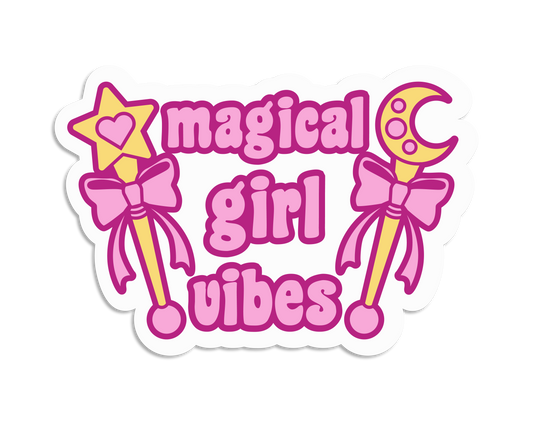 A diecut sticker featuring two gold wands with pink bows and pink text reading "Magical girl vibes"