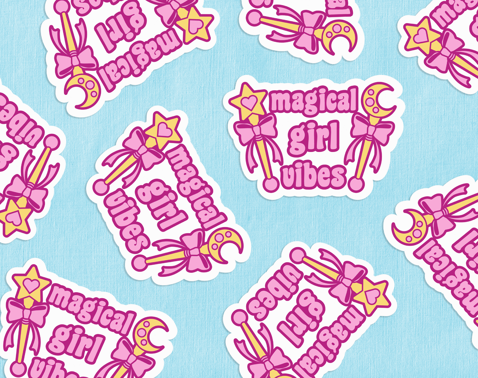 A group of diecut stickers featuring two gold wands with pink bows and pink text reading "Magical girl vibes" against a blue paper backdrop